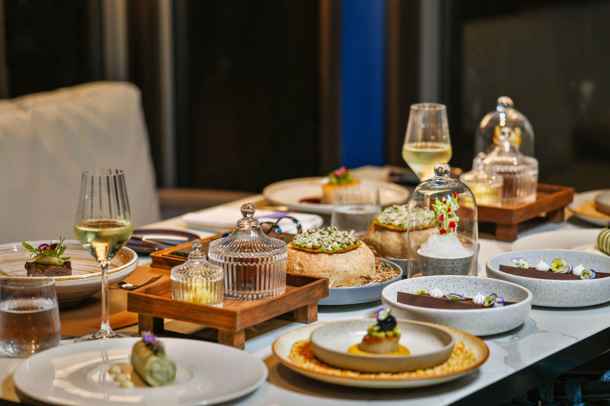 Elegant gourmet dishes and glassware set on a table for a private dining or corporate hospitality event.